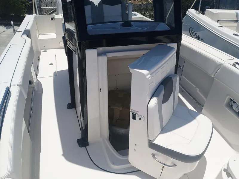 Slide: The Image of 2024 Robalo R250 Center Console boat interior with seating and storage area. - 19