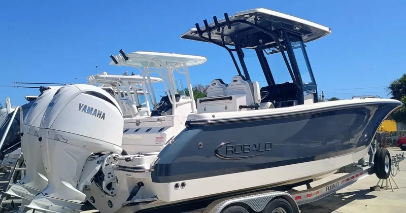 Slide: The Image of 2024 Robalo R250 Center Console boat with Yamaha engines on a trailer. - 2