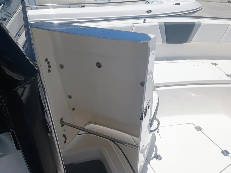 Slide: The Image of 2024 Robalo R250 Center Console boat interior storage compartment open. - 20