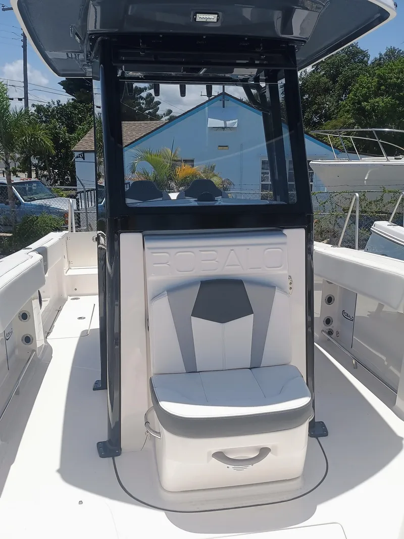 Slide: The Image of 2024 Robalo R250 Center Console boat interior with seating and console view. - 21