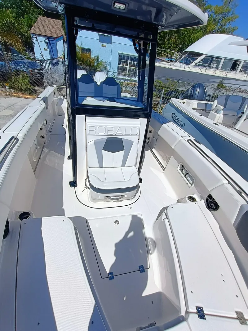 Slide: The Image of 2024 Robalo R250 Center Console boat interior with seating and console view. - 25