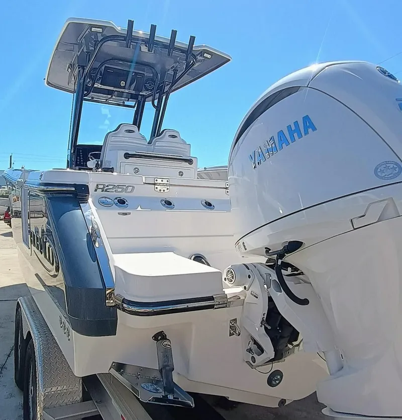 Slide: The Image of 2024 Robalo R250 Center Console boat with Yamaha engine, displayed on a trailer. - 7