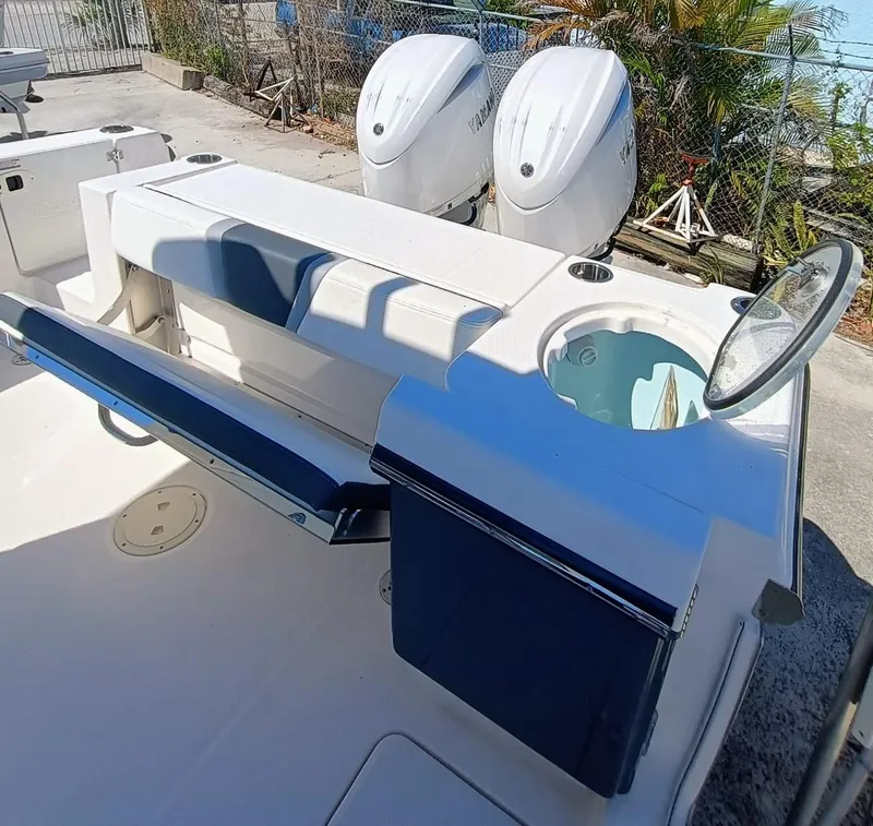 Slide: The Image of 2024 Robalo R250 Center Console boat with dual engines and seating area. - 9