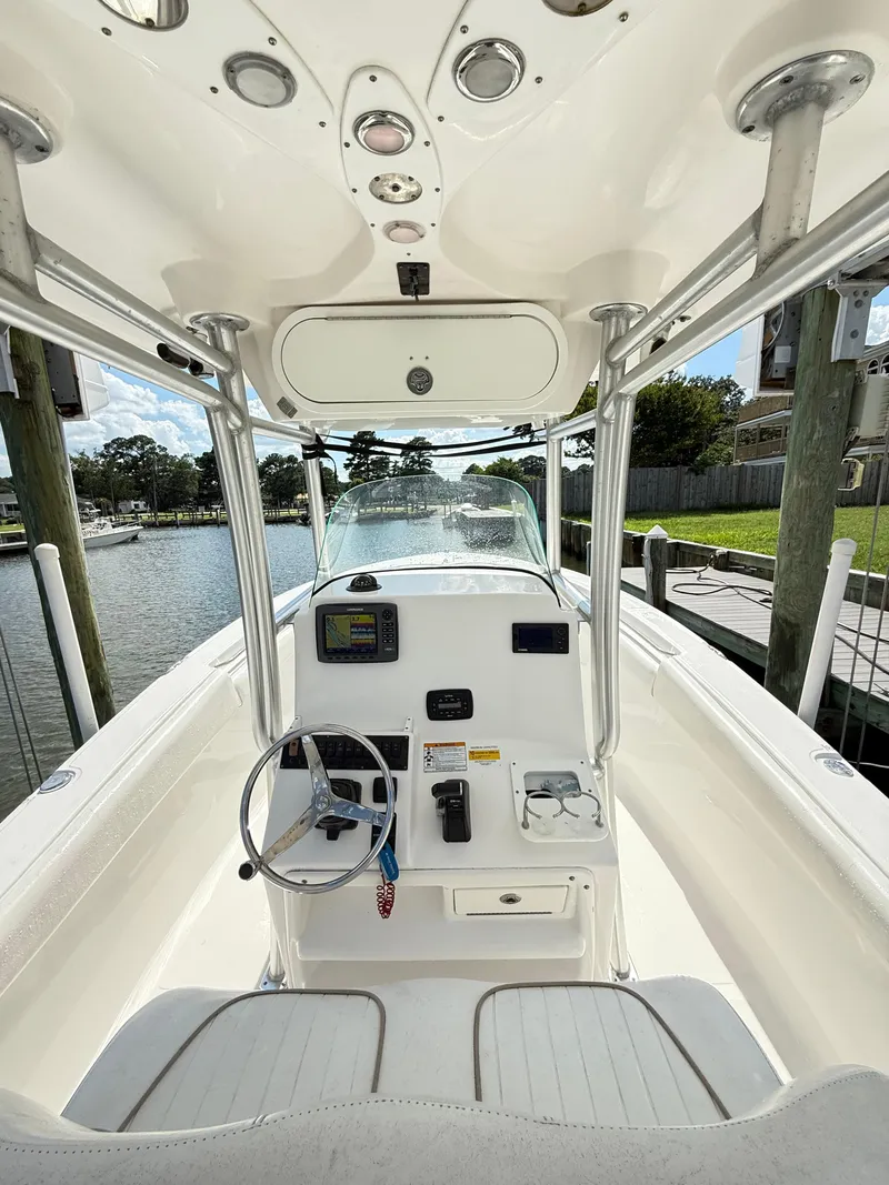 Slide: The Image of 2015 Sea Fox 256 Commander boat cockpit with steering wheel and navigation equipment. - 13