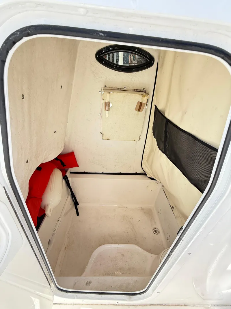 Slide: The Image of Interior cabin of 2015 Sea Fox 256 Commander boat, featuring storage and safety equipment. - 14
