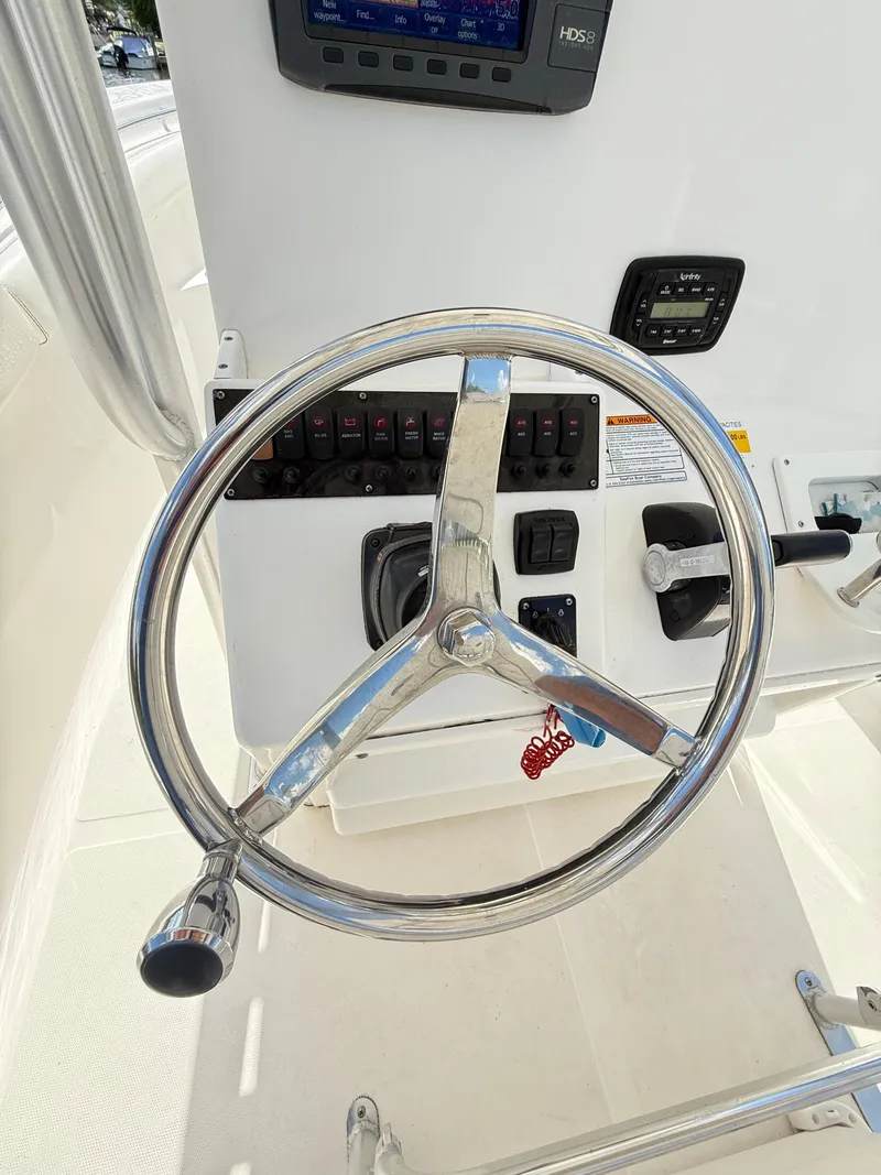 Slide: The Image of Steering wheel and controls of 2015 Sea Fox 256 Commander boat. - 18