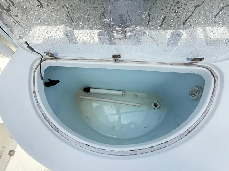 Slide: The Image of Livewell compartment on a 2015 Sea Fox 256 Commander boat, with water and plumbing visible. - 30
