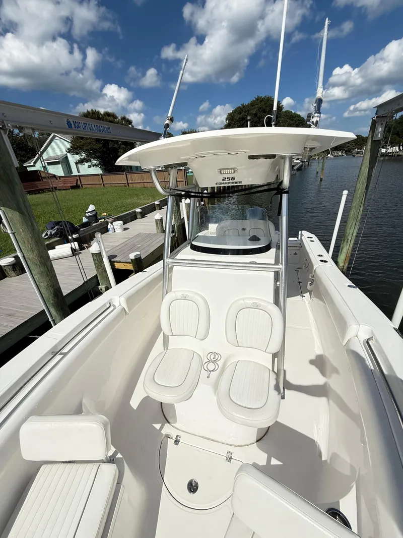 Slide: The Image of 2015 Sea Fox 256 Commander boat docked under a clear blue sky. - 8