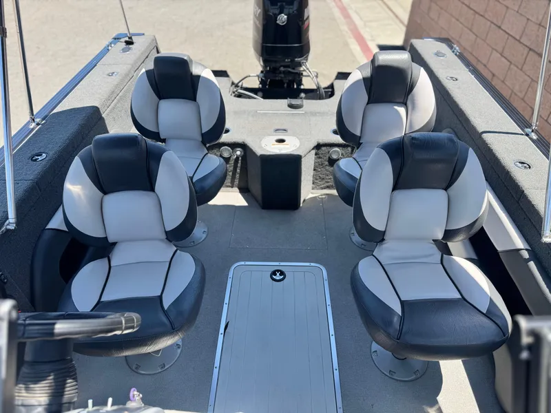 Slide: The Image of 2013 Smoker Craft Ultima 172 boat interior with four cushioned seats and motor. - 12