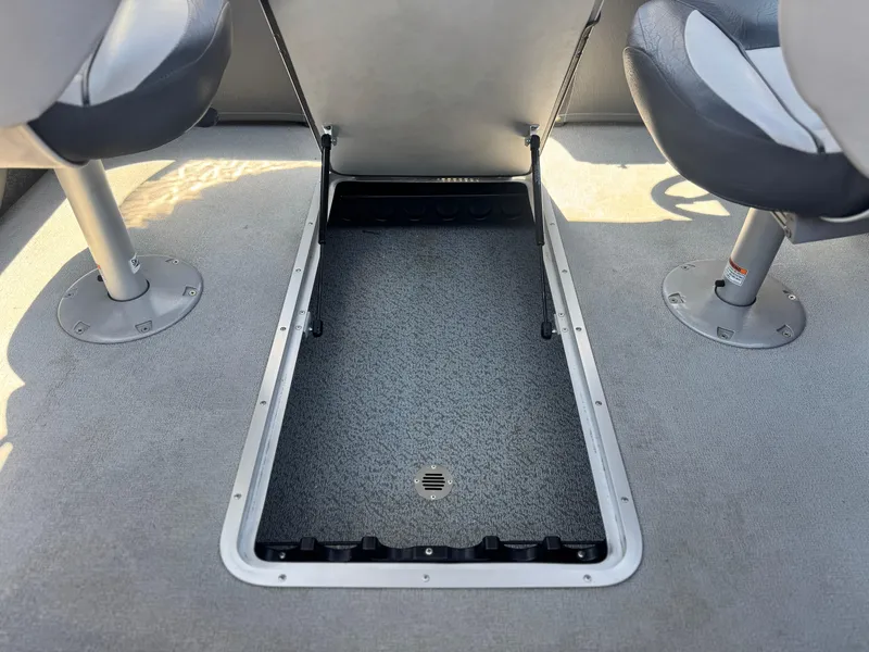 Slide: The Image of 2013 Smoker Craft Ultima 172 boat interior with open storage compartment between seats. - 13