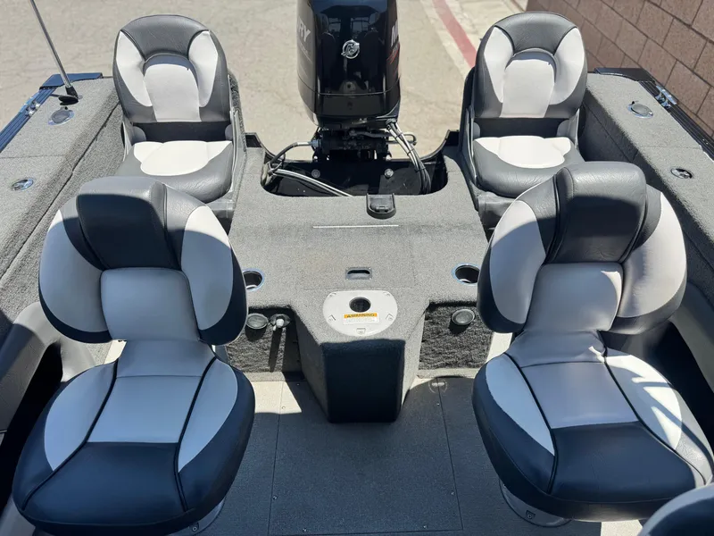 Slide: The Image of 2013 Smoker Craft Ultima 172 boat interior with four cushioned seats and motor. - 14