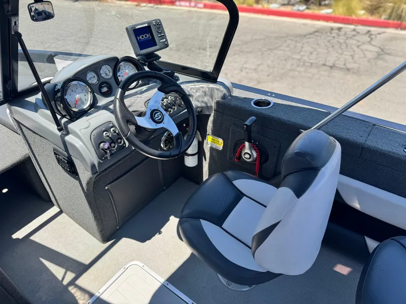 Slide: The Image of 2013 Smoker Craft Ultima 172 boat interior with steering wheel and control panel. - 16