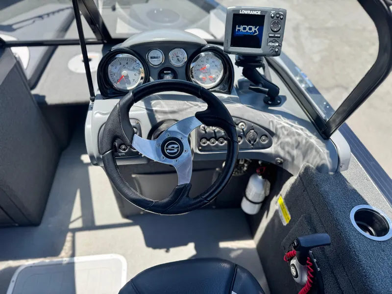 Slide: The Image of 2013 Smoker Craft Ultima 172 boat dashboard with steering wheel and Lowrance fish finder. - 17