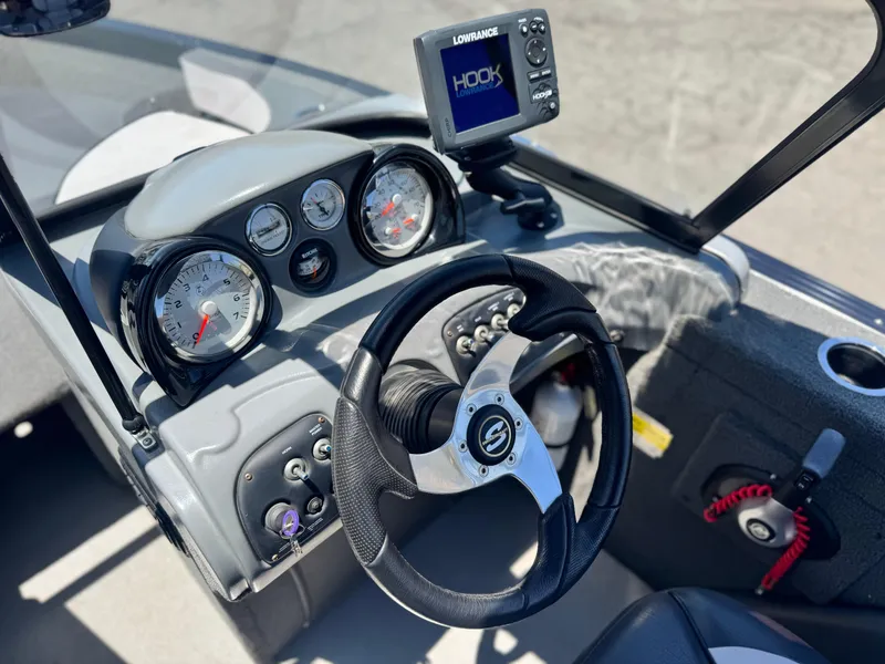 Slide: The Image of 2013 Smoker Craft Ultima 172 dashboard with steering wheel and Lowrance fish finder. - 18