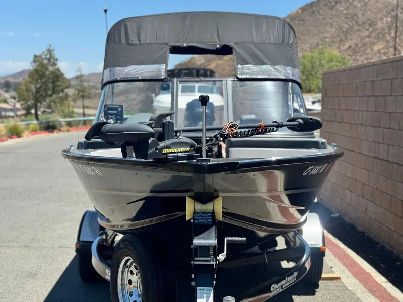 Slide: The Image of 2013 Smoker Craft Ultima 172 boat on trailer, parked outdoors. - 2