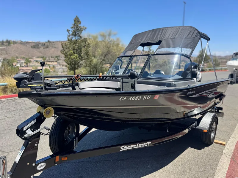 Slide: The Image of 2013 Smoker Craft Ultima 172 boat on trailer, parked outdoors on a sunny day. - 3