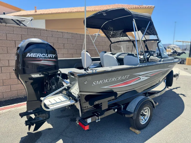Slide: The Image of 2013 Smoker Craft Ultima 172 boat with Mercury outboard motor, parked outdoors. - 5