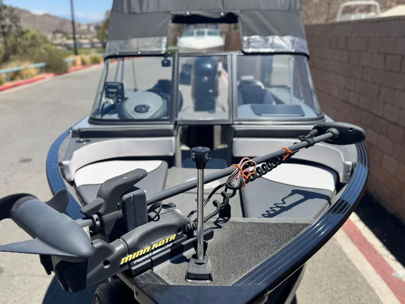 Slide: The Image of 2013 Smoker Craft Ultima 172 boat with Minn Kota trolling motor, parked outdoors. - 9