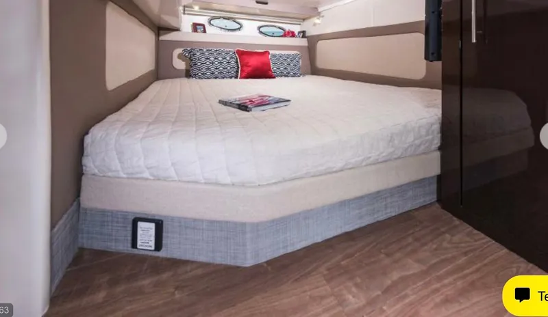 Slide: The Image of 2017 Regal 46 Sport Coupe interior cabin with bed and decorative pillows. - 11