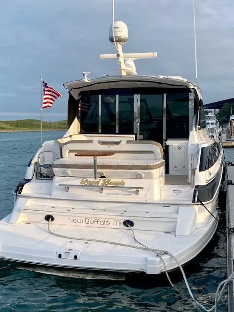 Slide: The Image of 2017 Regal 46 Sport Coupe yacht docked in New Buffalo, MI, with American flag. - 15