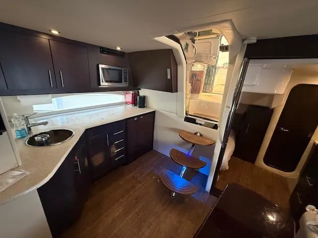 Slide: The Image of Luxurious interior of 2017 Regal 46 Sport Coupe yacht with modern kitchen and stylish seating. - 16