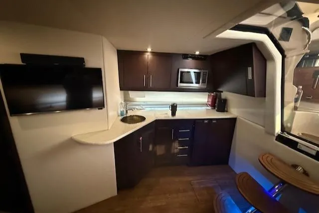 Slide: The Image of Luxurious interior of 2017 Regal 46 Sport Coupe yacht with modern kitchen amenities. - 22