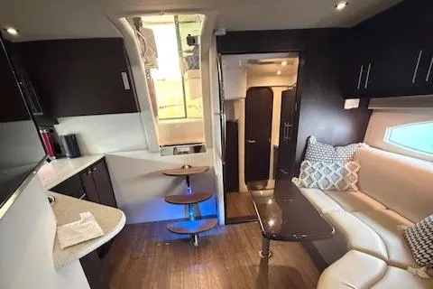 Slide: The Image of Interior of 2017 Regal 46 Sport Coupe with modern kitchen and cozy seating area. - 23