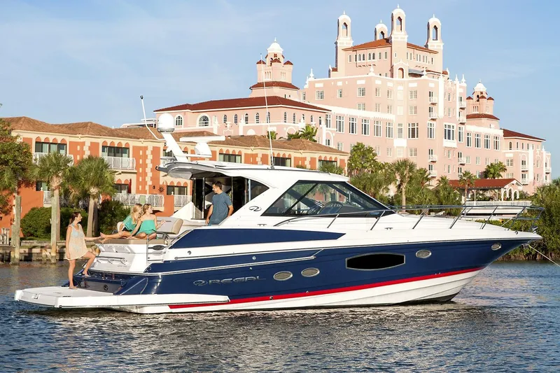 Slide: The Image of Manufacturer Provided Image: 2017 Regal 46 Sport Coupe yacht cruising near luxurious waterfront buildings. - 30