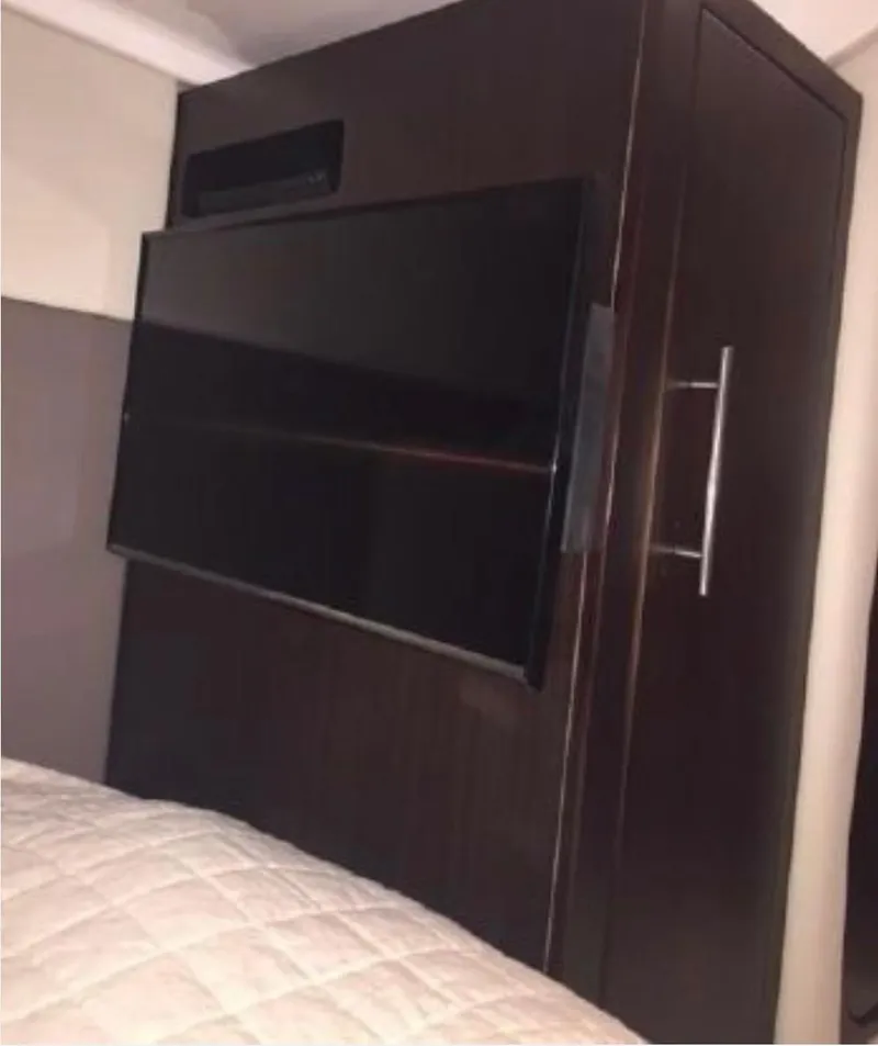 Slide: The Image of Interior of 2017 Regal 46 Sport Coupe with mounted TV and wooden cabinetry. - 6