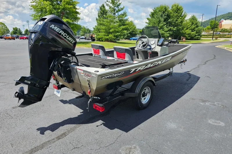 Slide: The Image of 2016 Tracker PRO160 boat with Mercury engine on a trailer in a parking lot. - 3