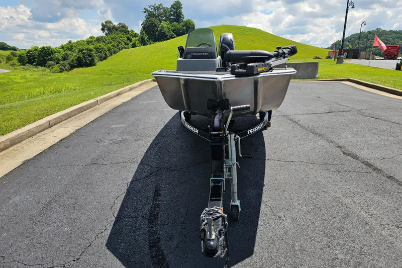Slide: The Image of 2016 Tracker PRO160 boat on trailer, parked on asphalt near grassy hill. - 7
