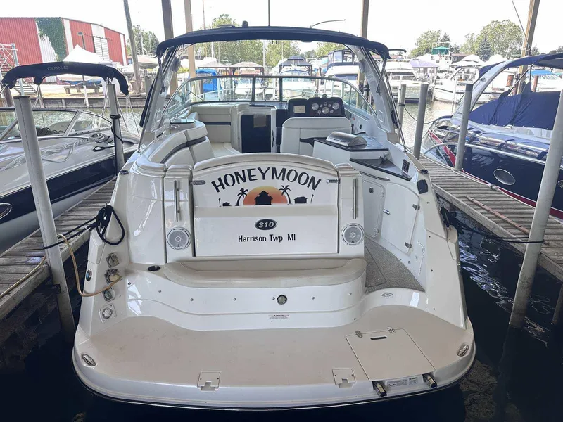 Slide: The Image of 2014 Rinker 310 Express Cruiser docked at marina, rear view. - 1
