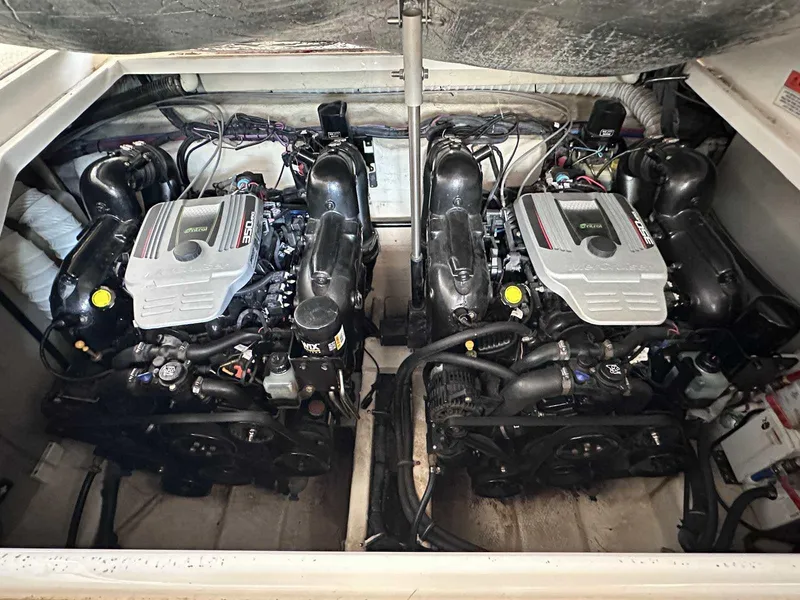 Slide: The Image of 2014 Rinker 310 Express Cruiser engine compartment with dual inboard motors. - 16