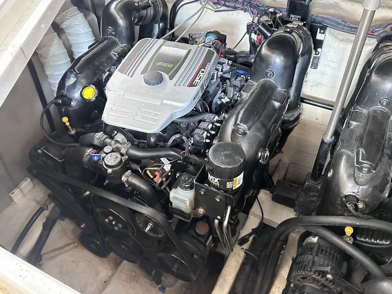 Slide: The Image of Engine compartment of a 2014 Rinker 310 Express Cruiser, showcasing a MerCruiser 350 engine. - 17