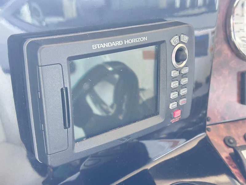 Slide: The Image of Control panel of a 2014 Rinker 310 Express Cruiser with keys and Fusion MS-NRX300. - 21