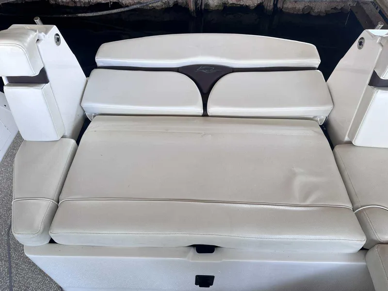 Slide: The Image of 2014 Rinker 310 Express Cruiser interior with white seating and modern design. - 3