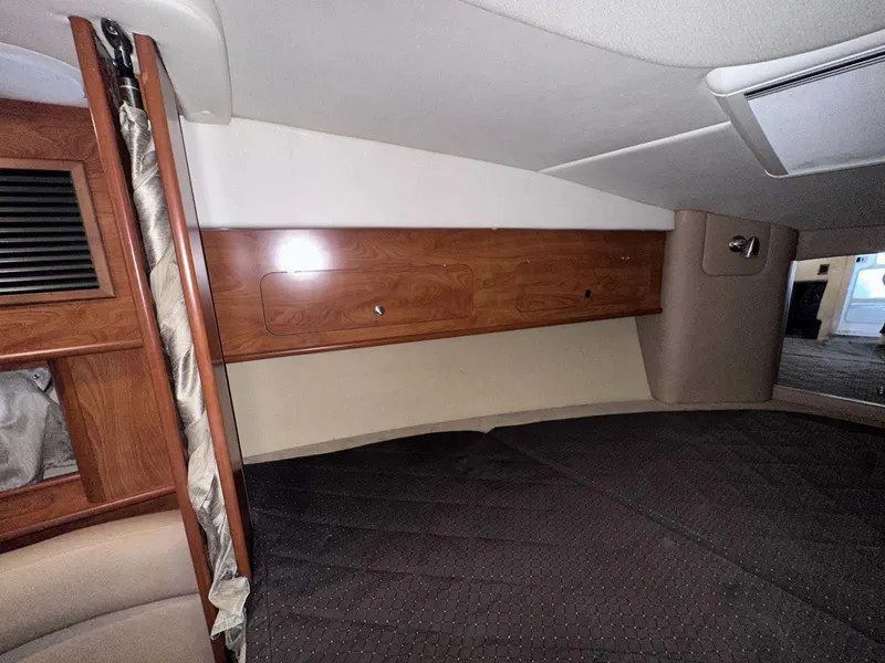 Slide: The Image of 2014 Rinker 310 Express Cruiser docked at a marina, view from the bow. - 31