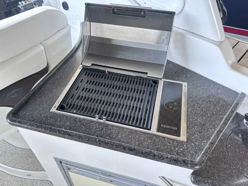 Slide: The Image of Open storage compartment with ropes on a 2014 Rinker 310 Express Cruiser. - 7