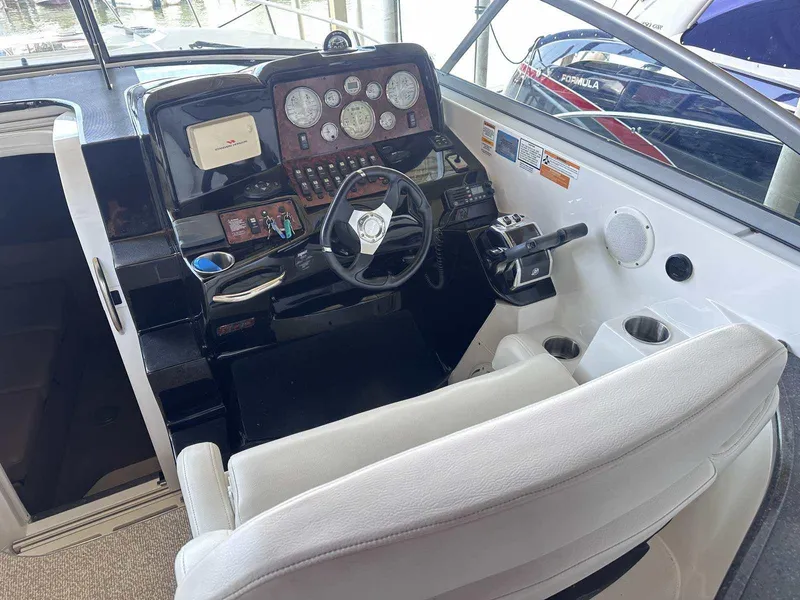 Slide: The Image of Built-in Kenyon grill on 2014 Rinker 310 Express Cruiser's sleek countertop. - 8