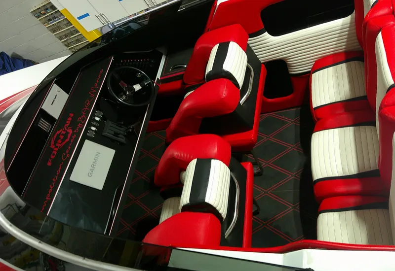 Slide: The Image of Interior of a 1993 Fountain 47 boat with red and white seating, Garmin navigation. - 10