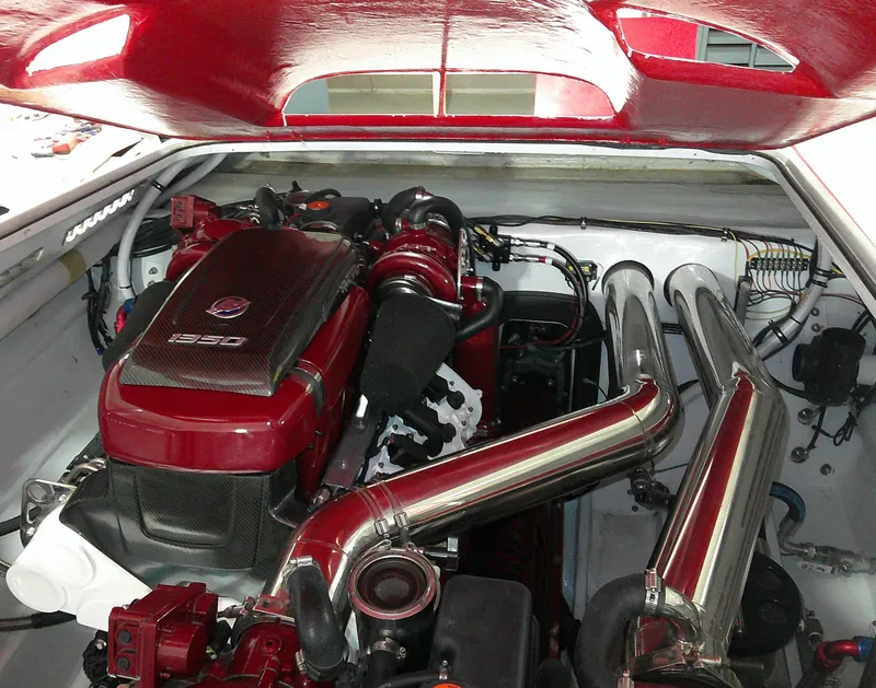 Slide: The Image of Engine of a 1993 Fountain 47 boat, featuring polished metal components and red accents. - 13