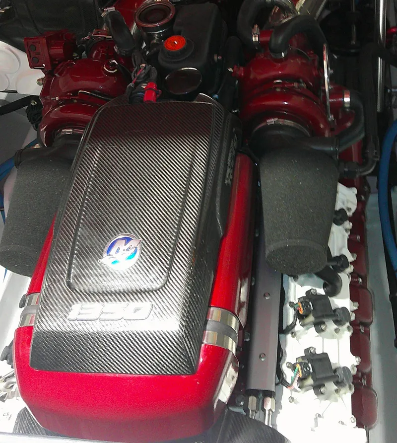 Slide: The Image of High-performance engine of a 1993 Fountain 47 boat, featuring carbon fiber components. - 14