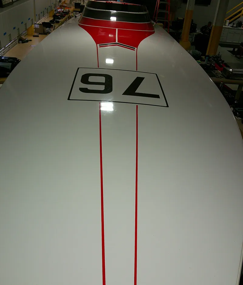 Slide: The Image of 1993 Fountain 47 boat with red stripes and number 76 on deck. - 3