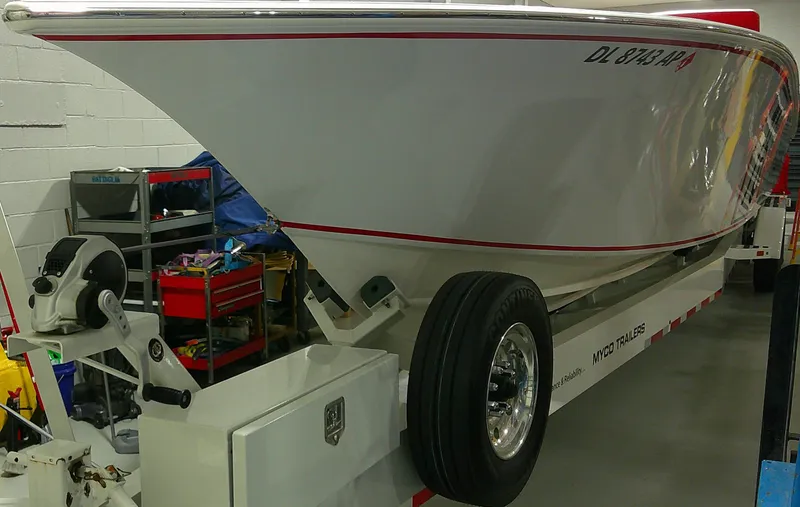 Slide: The Image of 1993 Fountain 47 boat on trailer in garage setting. - 4