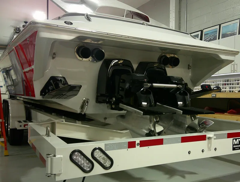 Slide: The Image of 1993 Fountain 47 boat on trailer in garage, showcasing powerful dual engines. - 6