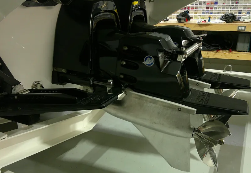 Slide: The Image of Twin outboard motors on a 1993 Fountain 47 boat in a workshop setting. - 7