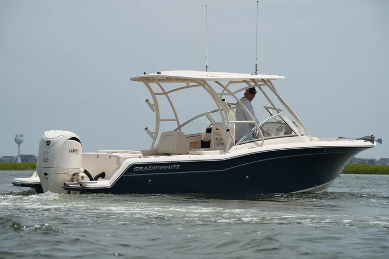 Slide: The Image of 2023 Grady-White Freedom 235 boat cruising on water, side view. - 10