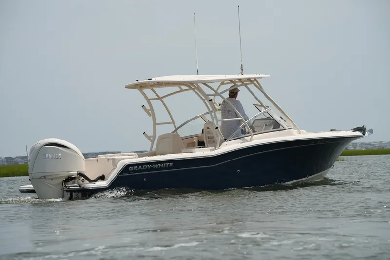 Slide: The Image of 2023 Grady-White Freedom 235 boat cruising on water. - 13