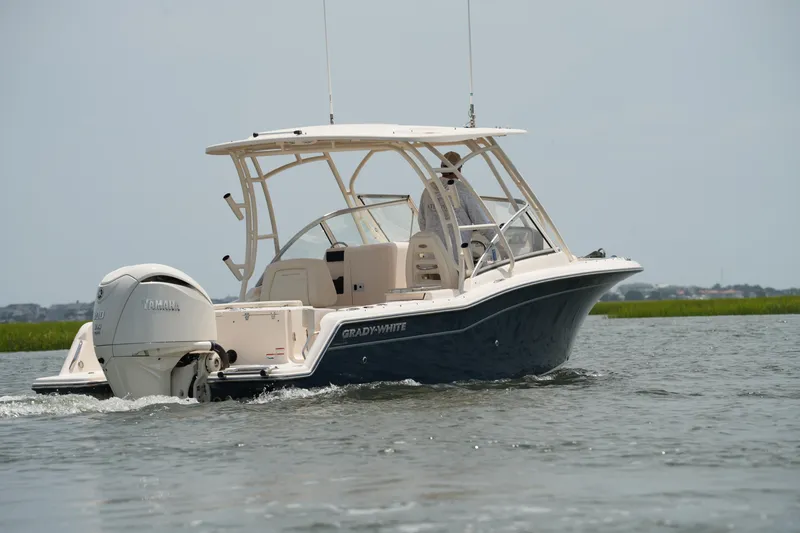 Slide: The Image of 2023 Grady-White Freedom 235 boat cruising on water with Yamaha engine. - 16