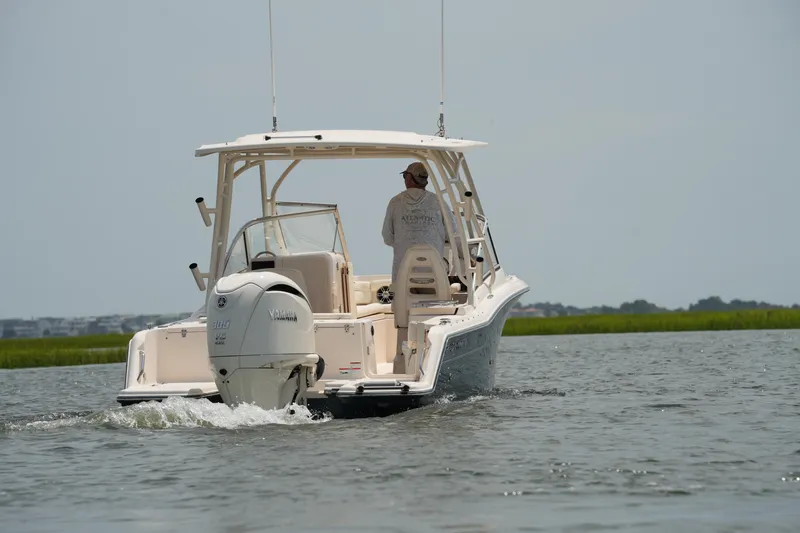 Slide: The Image of 2023 Grady-White Freedom 235 boat cruising on calm water. - 17